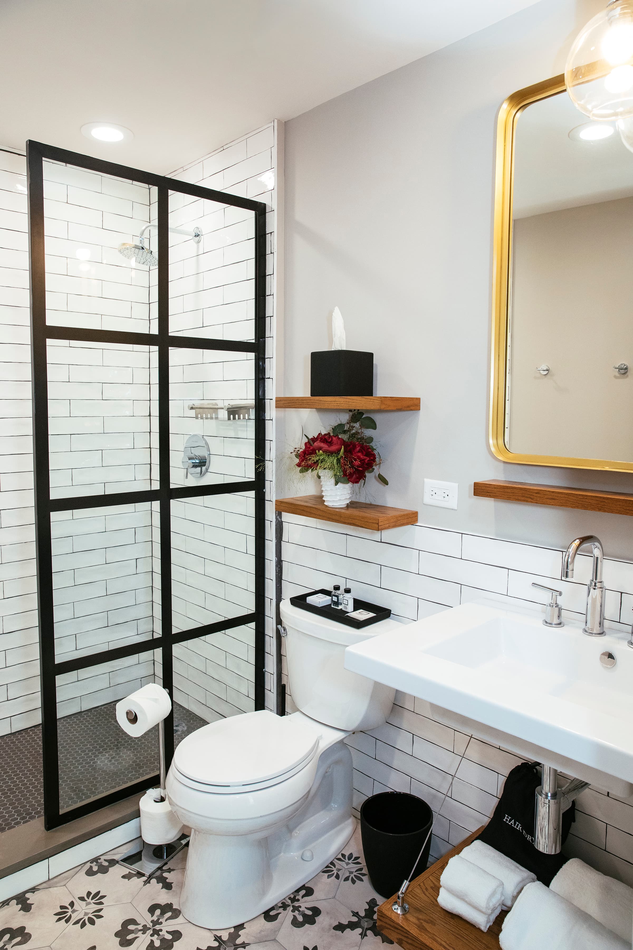 Concord's ensuite bathroom, showing the glass shower door, fluffy towels, large sink and included toiletries.