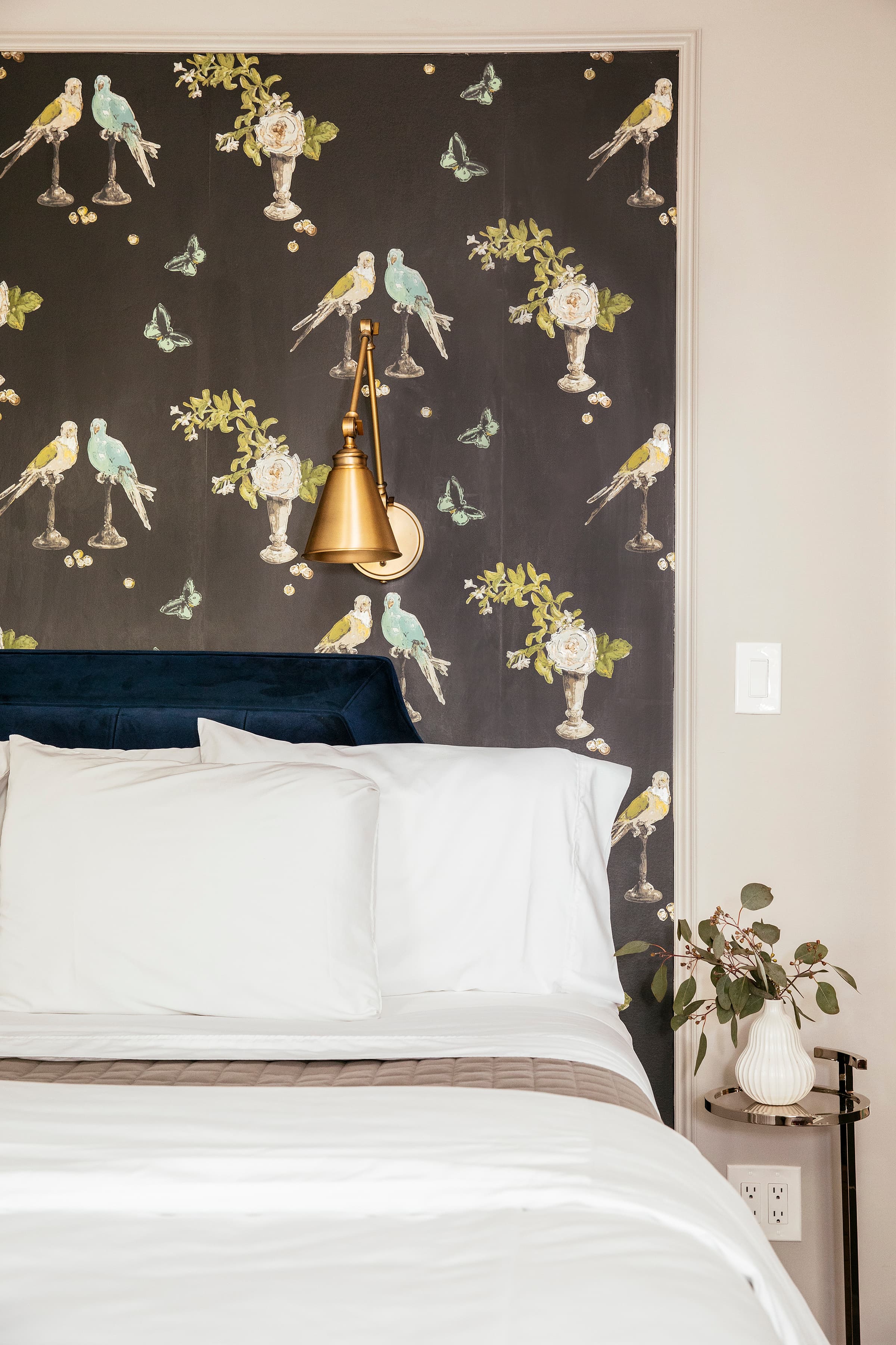 elegant bird wallpaper with brass bed lamp