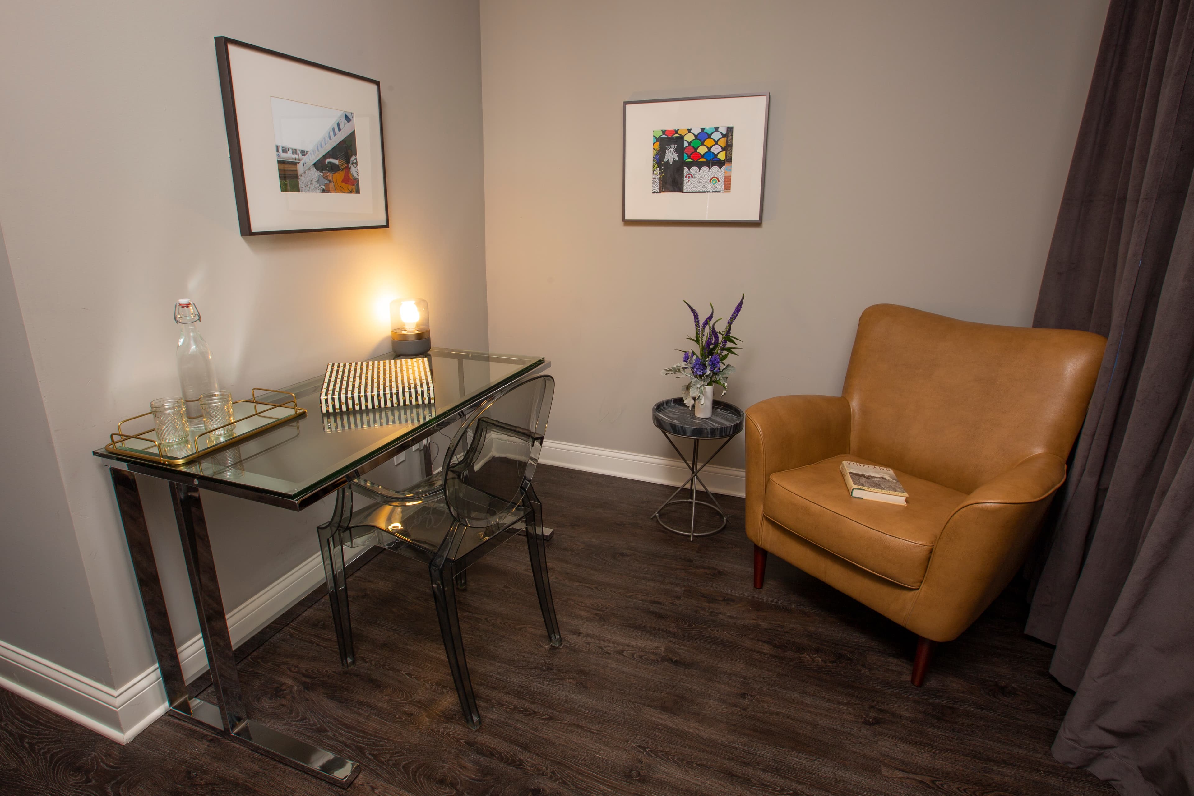 Ellen's desk and chair, with a green plant on a stand between them.