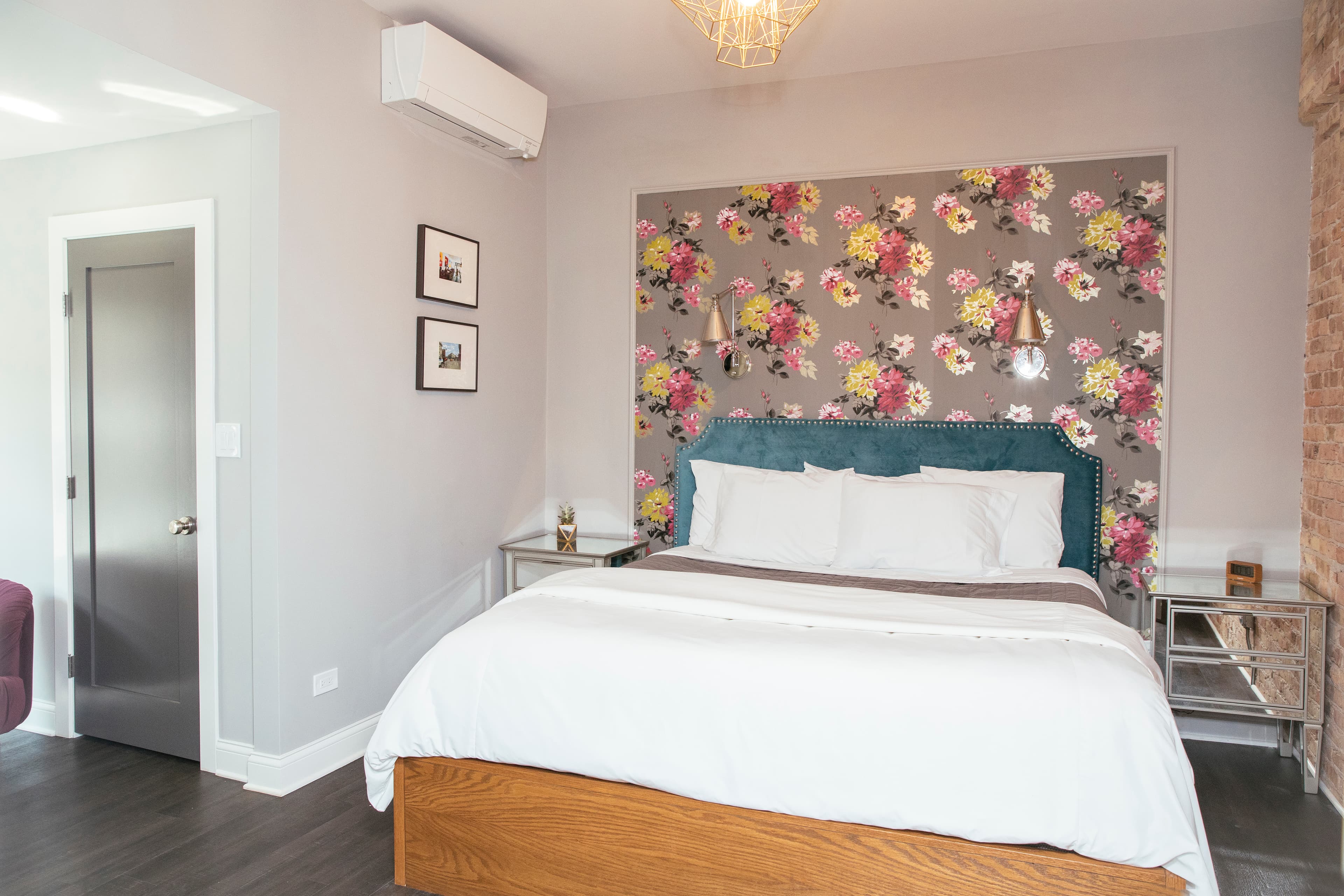 Schiller's spacious floorplan, including bed, armchair, closet door, windows and nightstand.