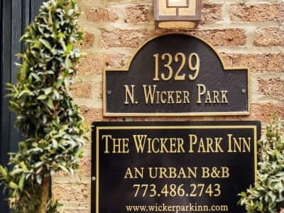 Sign for The Wicker Park Inn, displaying the address 1329 N. Wicker Park and contact information.
